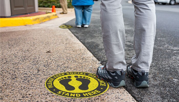 People standing in line with 6 feet of social distance between them